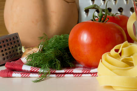 Ingredients for cooking pasta with tomatoes and herbsの写真素材