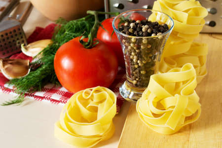 Ingredients for cooking pasta with tomatoes and herbsの写真素材