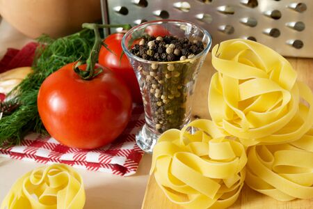 Ingredients for cooking pasta with tomatoes and herbsの写真素材
