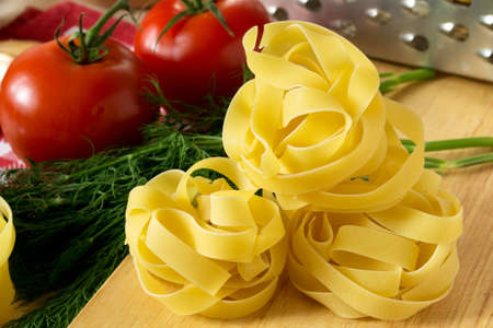 Ingredients for cooking pasta with tomatoes and herbsの写真素材