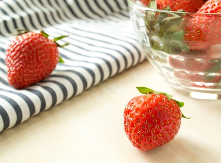 Strawberries in a glass on the tableの写真素材