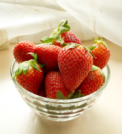 Strawberries in a glass on the tableの写真素材