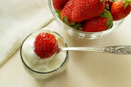strawberries with cream cheese in a glass on the tableの写真素材