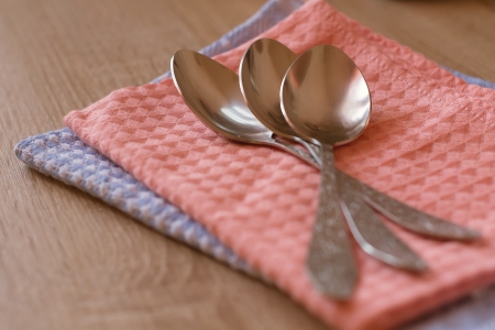 spoon lying on a towelの写真素材