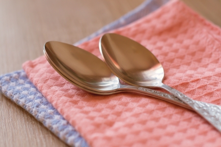 spoon lying on a towelの写真素材
