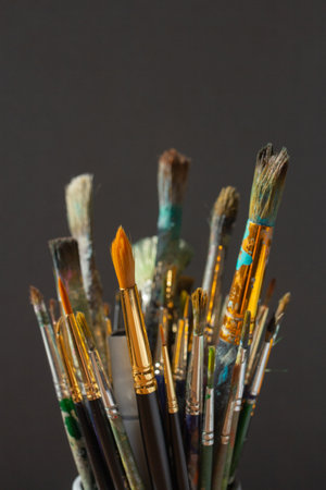 Paint brushes closeup on gray background, set of artist supplies, dirty brush, art toolsの写真素材