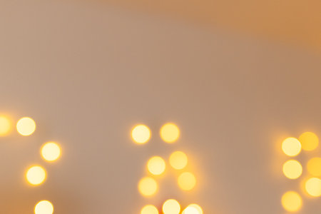 Bright golden and yellow blurred lights. Defocused abstract bokeh background with copy space....