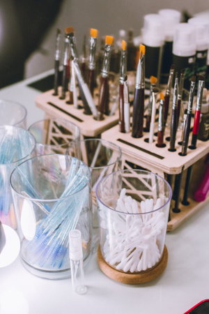 Eyebrows beauty master workplace table with brushes, removal, skincare objectsの写真素材