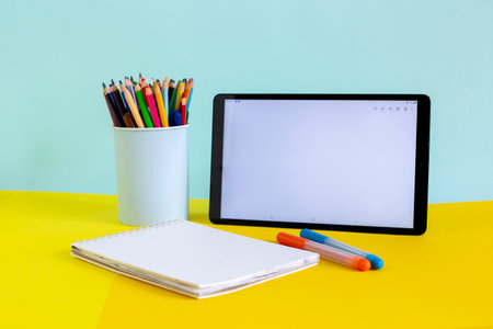Tablet and notebook for online study on yellow and blue
