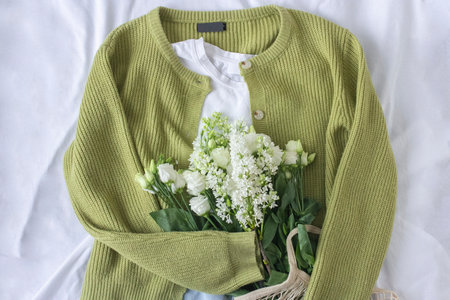 Eco fashion blogger content with clothes flat lay and white flowers in shopping bag, Denim jeans...