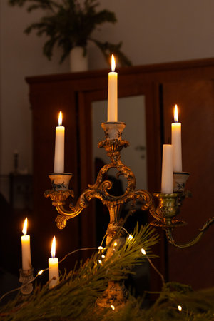 Burning candles on dark background at home. Candlestick close up. Fire, flame, smoke and candlelightの写真素材