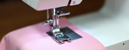 efficient industrial sewing process on pink fabric in factory environment for apparel productionの素材