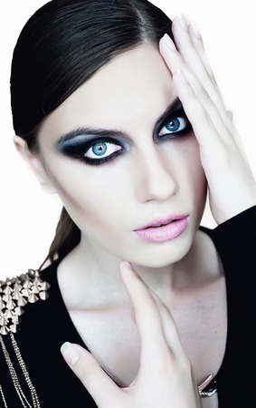 Young beautiful woman in black with gothic fashion makeup , posing on white backroundの写真素材