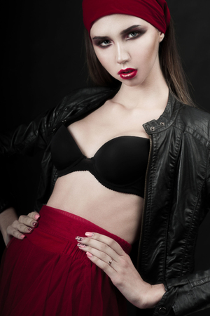High fashion look.glamor closeup beauty portrait of beautiful Caucasian young woman model with bright makeup with perfect clean skin with colorful red lipの写真素材