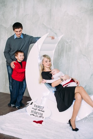 Portrait of friendly family looking at camera on Christmas eveningの写真素材