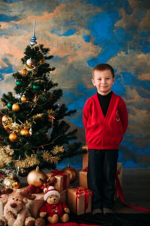 Portrait of adorable boy with giftboxesの写真素材