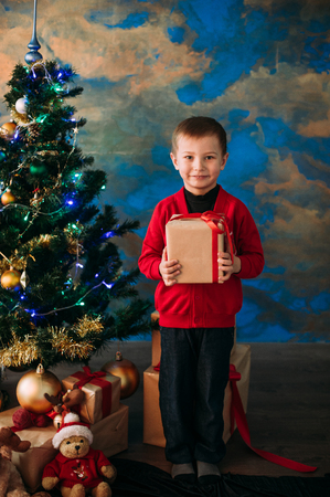 Portrait of adorable boy with giftboxesの写真素材