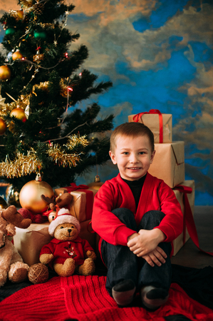 Portrait of adorable boy with giftboxesの写真素材