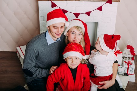Portrait of friendly family looking at camera on Christmas eveningの写真素材