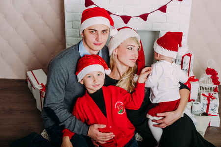 Portrait of friendly family looking at camera on Christmas eveningの写真素材