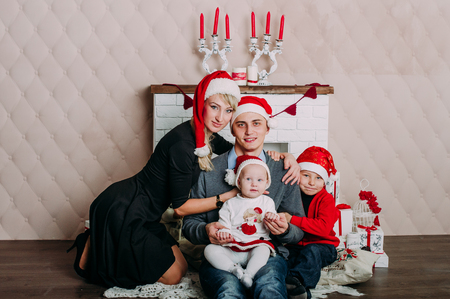 Portrait of friendly family looking at camera on Christmas eveningの写真素材