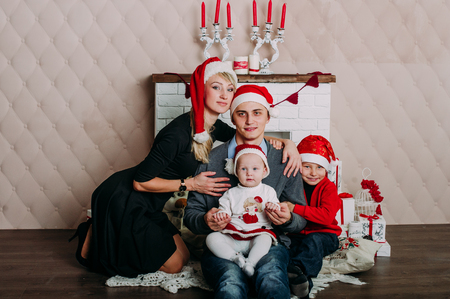 Portrait of friendly family looking at camera on Christmas eveningの写真素材