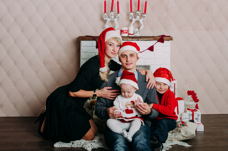 Portrait of friendly family looking at camera on Christmas eveningの写真素材