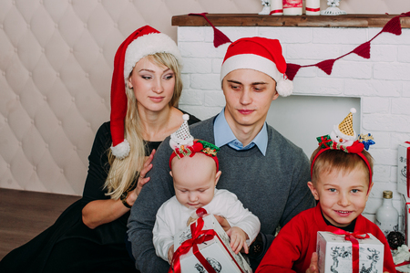 Portrait of friendly family looking at camera on Christmas eveningの写真素材