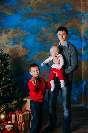 Portrait of friendly family looking at camera on Christmas eveningの写真素材