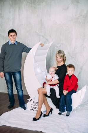 Portrait of friendly family looking at camera on Christmas eveningの写真素材