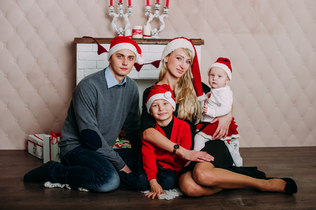 Portrait of friendly family looking at camera on Christmas eveningの写真素材