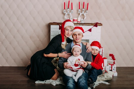 Portrait of friendly family looking at camera on Christmas eveningの写真素材