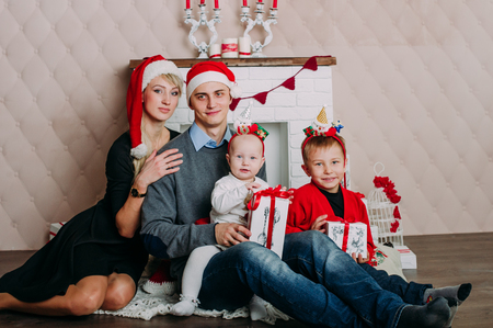 Portrait of friendly family looking at camera on Christmas eveningの写真素材