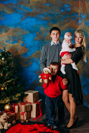 Portrait of friendly family looking at camera on Christmas eveningの写真素材