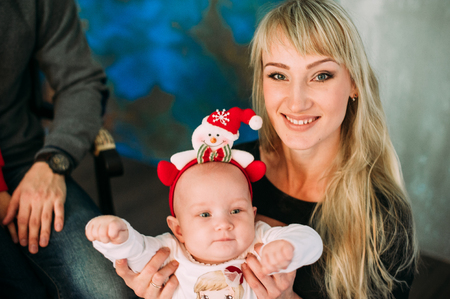 Portrait of friendly family looking at camera on Christmas eveningの写真素材