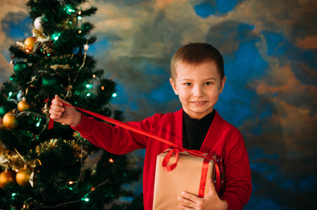 Portrait of adorable boy with giftboxesの写真素材