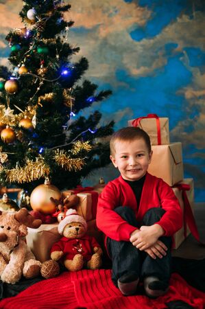Portrait of adorable boy with giftboxesの写真素材