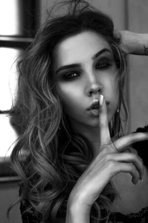 Gorgeous model girl in a lace body, posing outdoors. Black and white fashion photoの写真素材