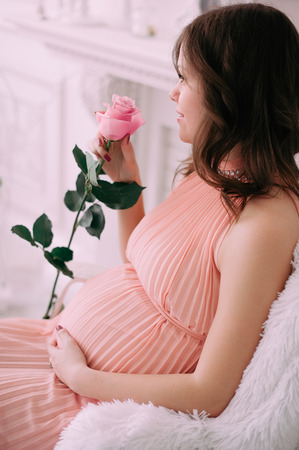 Happy pregnant young woman waiting for a childの写真素材