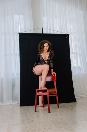 Sexy and beautiful woman wearing black lace body lingerie with curly hairの写真素材