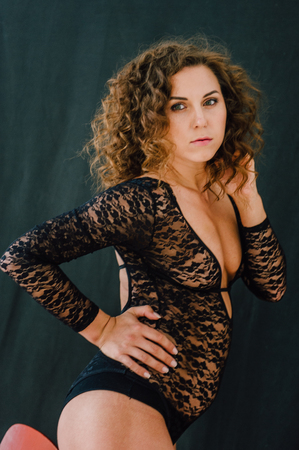 Sexy and beautiful woman wearing black lace body lingerie with curly hairの写真素材