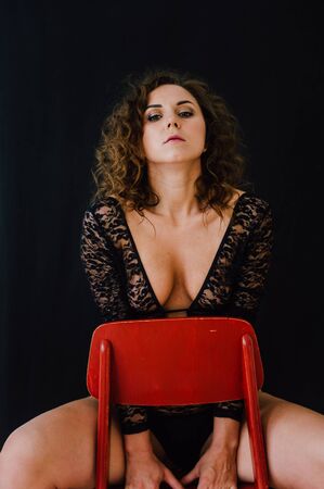 Sexy and beautiful woman wearing black lace body lingerie with curly hairの写真素材