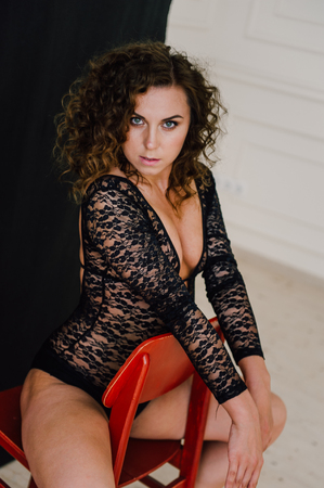 Sexy and beautiful woman wearing black lace body lingerie with curly hairの写真素材