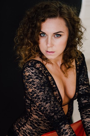Sexy and beautiful woman wearing black lace body lingerie with curly hairの写真素材