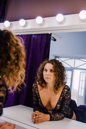Sexy and beautiful woman wearing black lace body lingerie with curly hairの写真素材