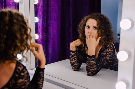 Sexy and beautiful woman wearing black lace body lingerie with curly hairの写真素材
