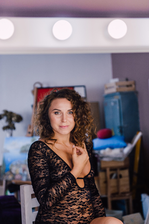 Sexy and beautiful woman wearing black lace body lingerie with curly hairの写真素材