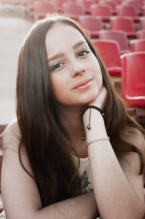 Girl having fun outdoor. Pretty girl sitting at school stadium. Rest from study. Outdoors, Lifestyleの写真素材