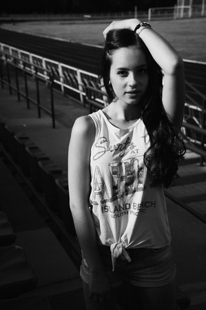 Girl having fun outdoor. Pretty girl sitting at school stadium. Rest from study. Outdoors, Lifestyleの写真素材
