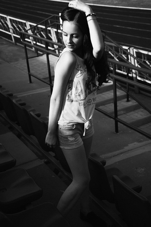 Girl having fun outdoor. Pretty girl sitting at school stadium. Rest from study. Outdoors, Lifestyleの写真素材